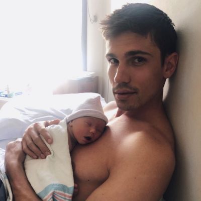 Photo of Tanner Novlan holding his daughter, Poppy Marie Novlan